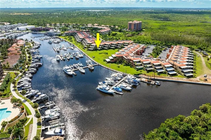 Aerial view of numerous boat docks and a nearby body of water