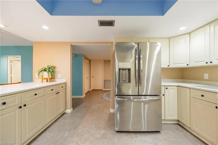 Kitchen with stainless steel fridge and recessed lighting
