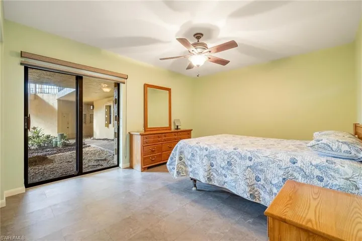 Bedroom with access to outside and ceiling fan