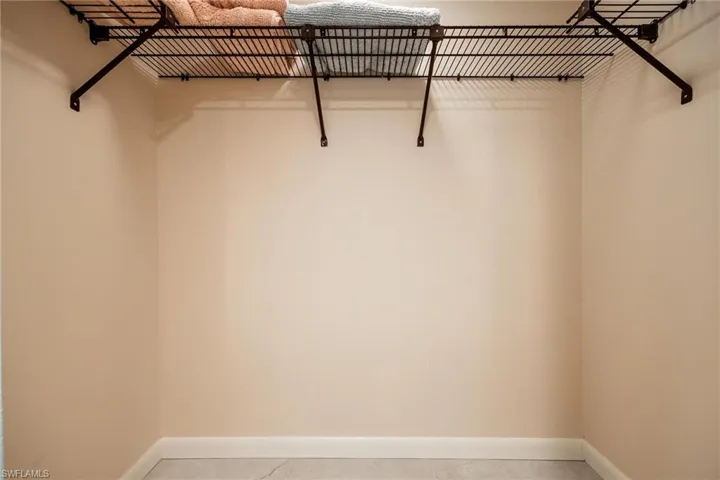 Spacious closet with light tile patterned floors
