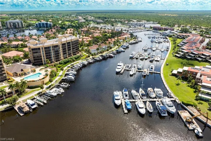 Drone / aerial view of numerous boat docks and a large body of water