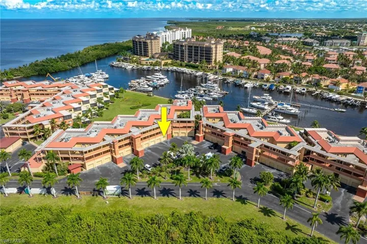 Aerial view of numerous boat docks and a large body of water