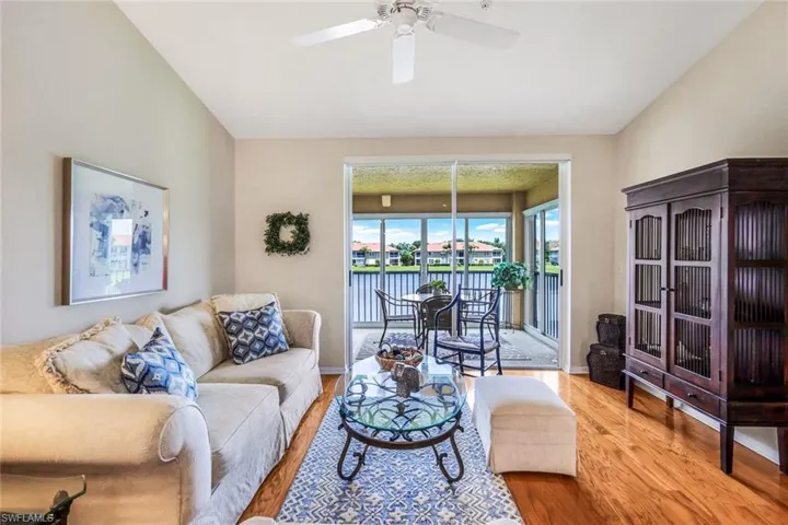 Living room with light wood-type flooring and ceiling fan