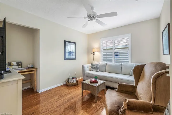 Living room featuring hardwood / wood-style flooring and ceiling fan