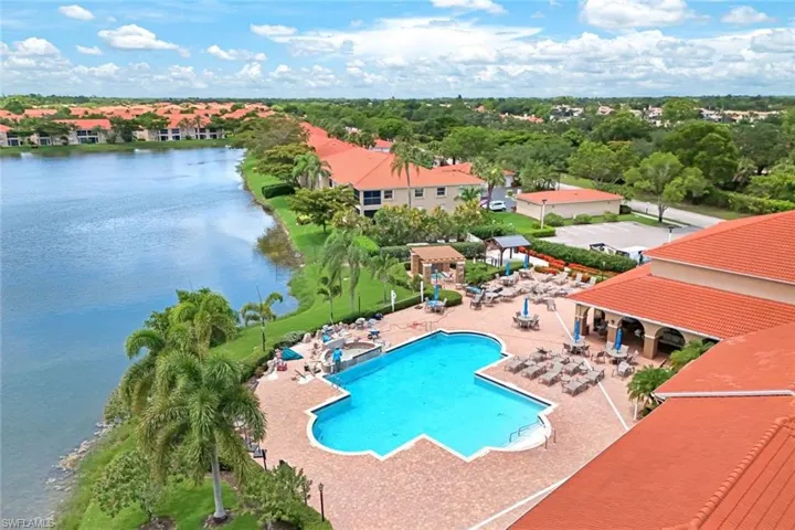 View of pool with a patio area and a water view
