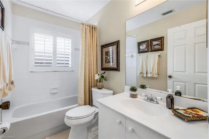 Full bathroom with shower / bath combination with curtain, toilet, and vanity
