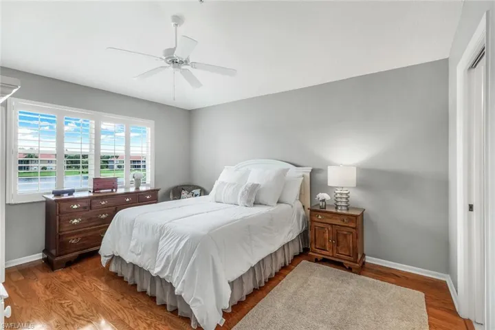 Bedroom featuring wood-type flooring and ceiling fan