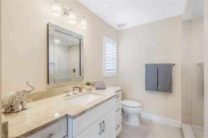 Bathroom with tile patterned floors, vanity, and toilet