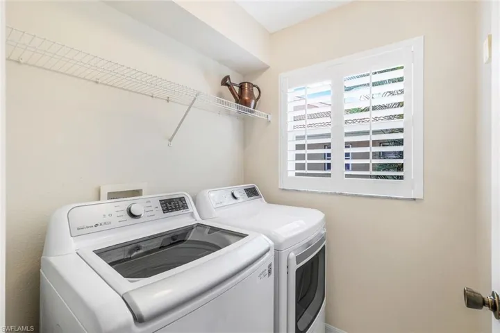 Washroom featuring washing machine and clothes dryer