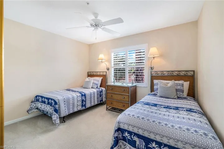 Carpeted bedroom featuring ceiling fan