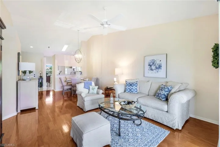 Living room with ceiling fan and light wood-type flooring