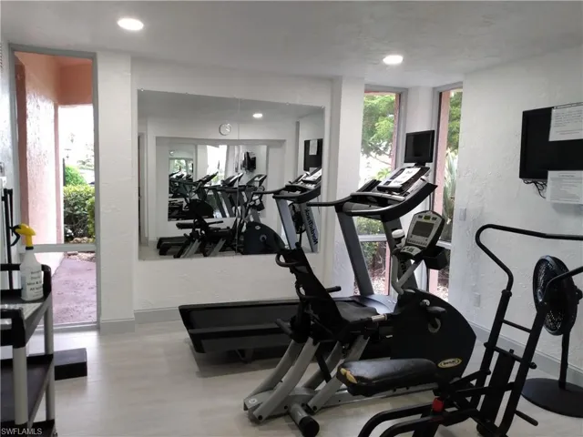Workout area with hardwood / wood-style flooring