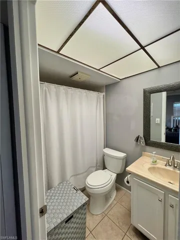 Bathroom featuring tile patterned floors, toilet, and vanity
