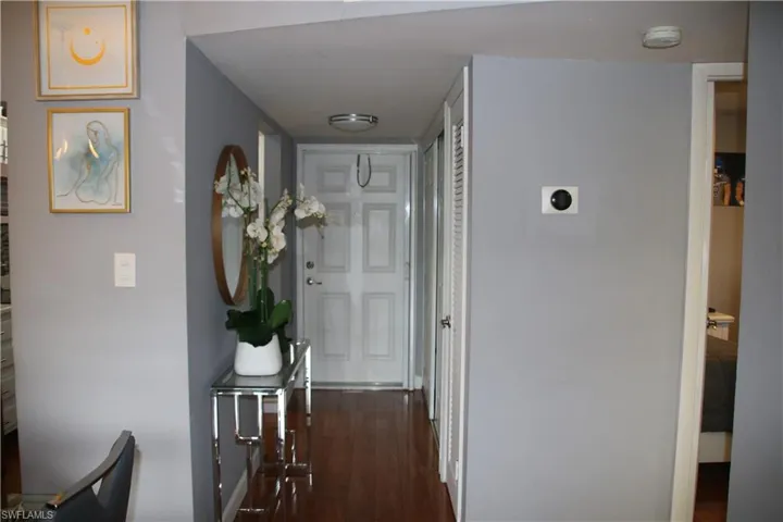 Hall with dark hardwood / wood-style floors