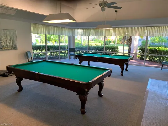 Recreation room featuring light carpet, ceiling fan, a healthy amount of sunlight, and pool table