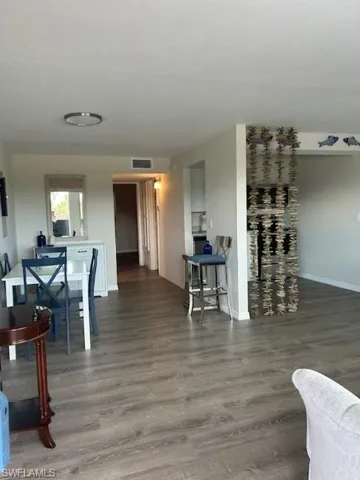 Living room with hardwood / wood-style flooring