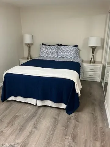 Bedroom with hardwood / wood-style flooring
