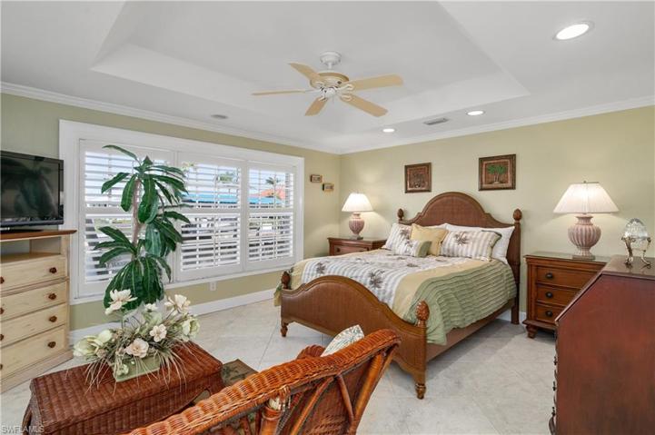 Second guest bedroom with a large windows that looks out to the canal.