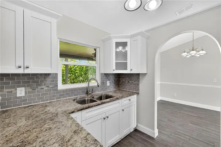 White Shaker Cabinets and window looking to the backyard