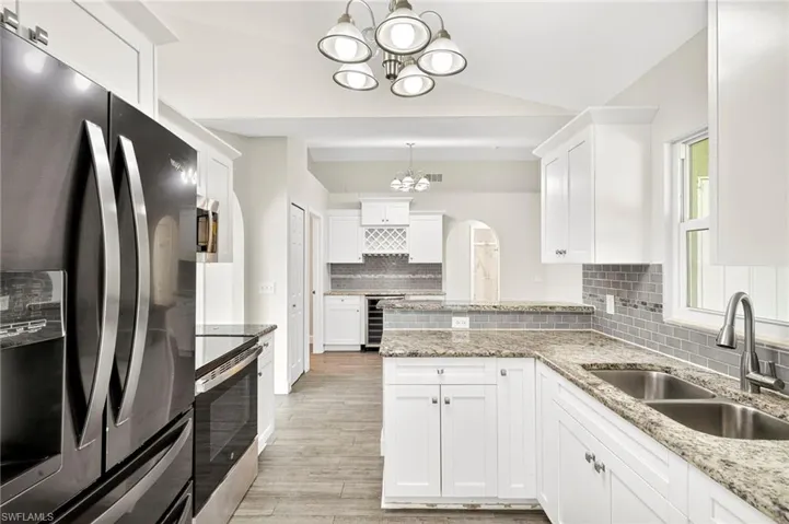 Kitchen with black appliances and beautiful countertops