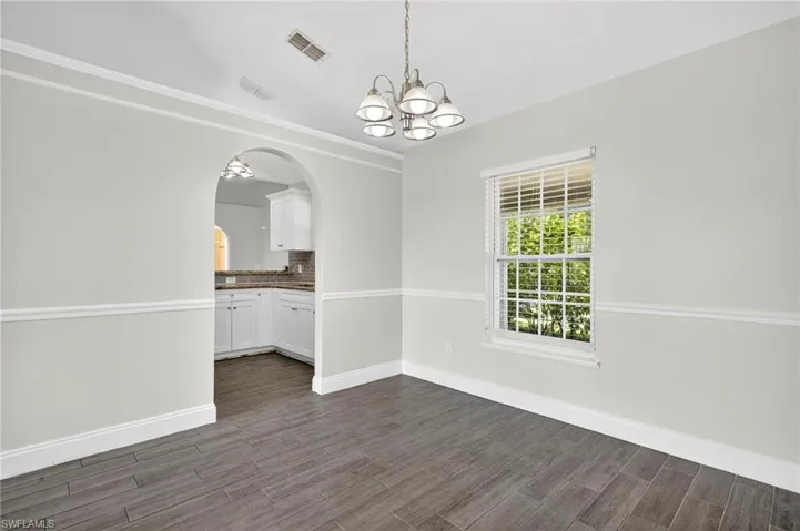The Dining with a separate arched entrance to the kitchen