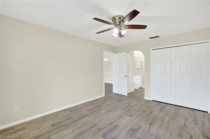 Spacious Primary Bedroom with Tile Floor and located on the opposite side of house as other bedrooms