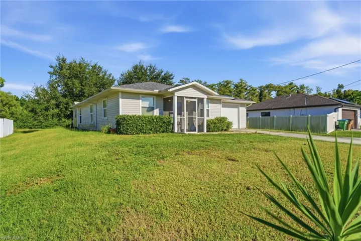 Ranch-style home with a sunroom and an attached garage