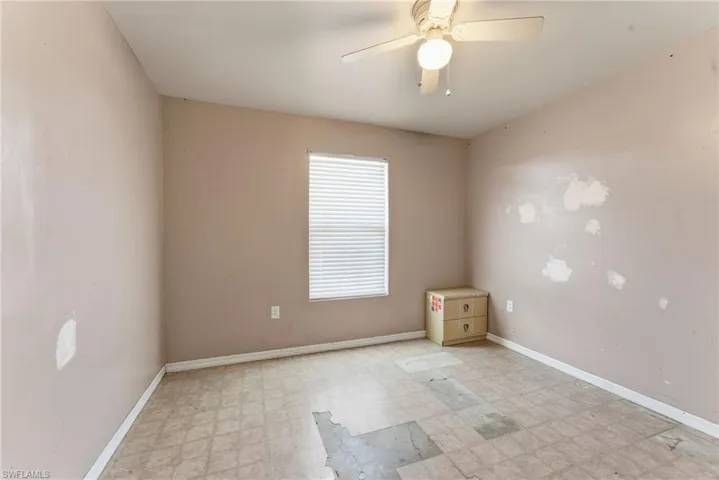 Spare room with light flooring and a ceiling fan