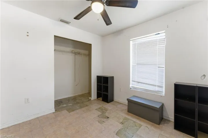 Unfurnished bedroom featuring a ceiling fan and a closet