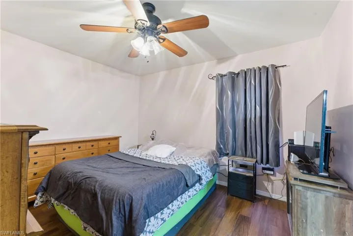 Bedroom featuring dark wood-type flooring and ceiling fan
