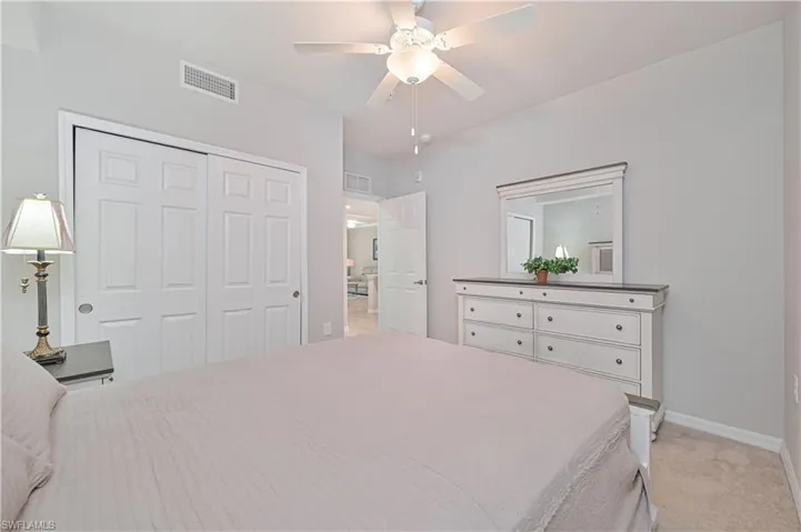 Private guest bedroom located within the home's desirable split-bedroom floor plan, providing comfort and privacy for visitors.