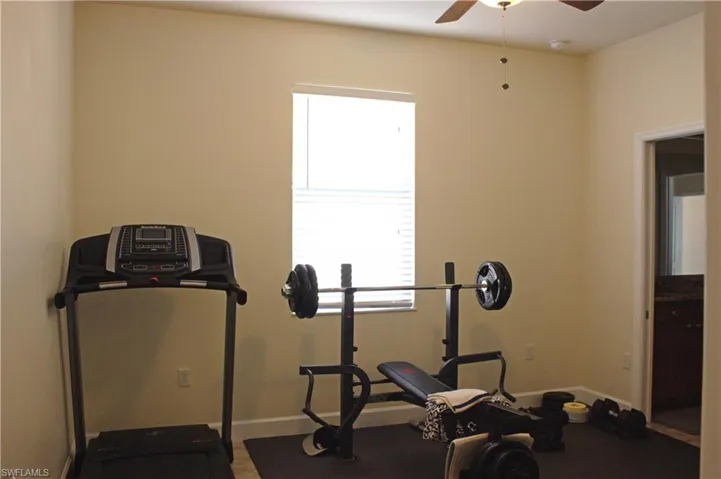 Versatile room featuring a ceiling fan, recessed lighting, and a large window with blinds