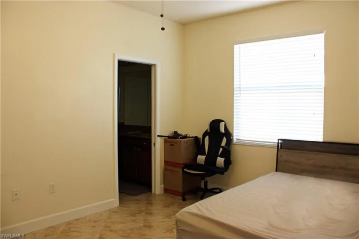 Spacious room with tile flooring and light-toned walls