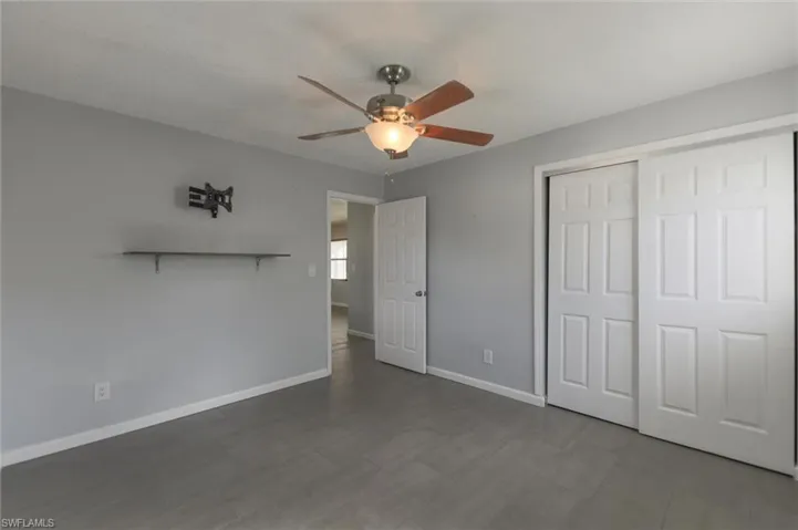 Unfurnished bedroom with a closet and ceiling fan
