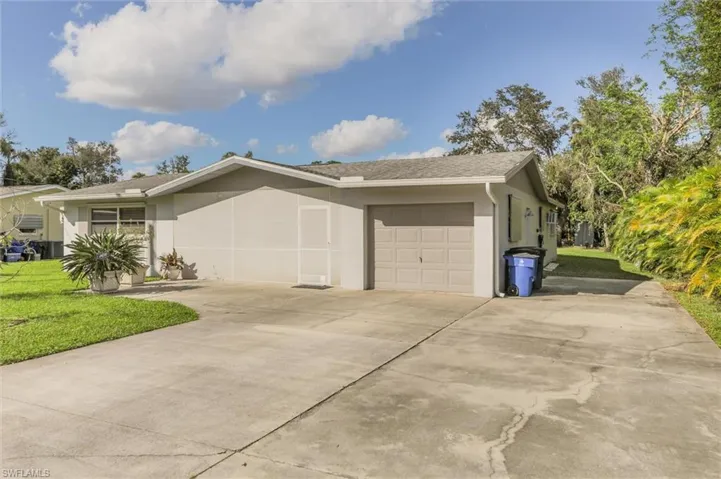 View of home's exterior with a lawn and a garage