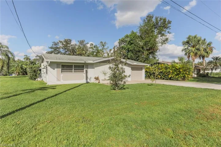 Ranch-style home with a front lawn and a garage