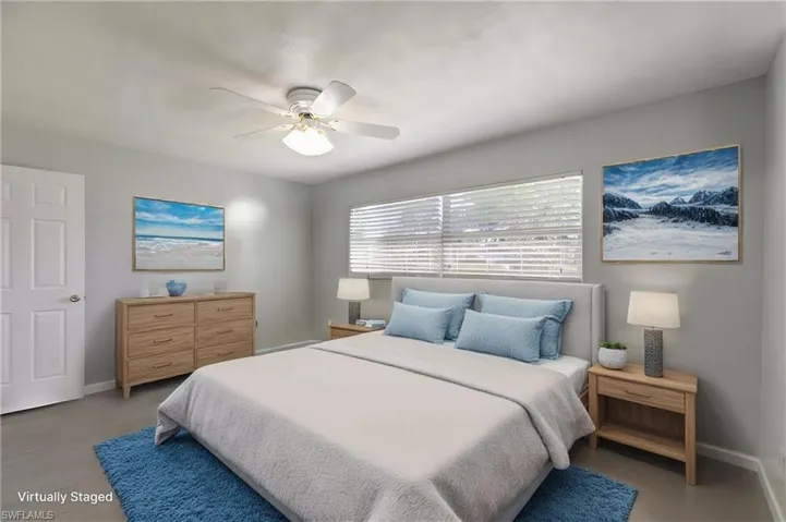 Virtually-staged bedroom featuring ceiling fan