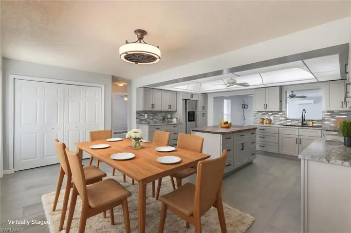 Virtually-staged dining area featuring ceiling fan and sink