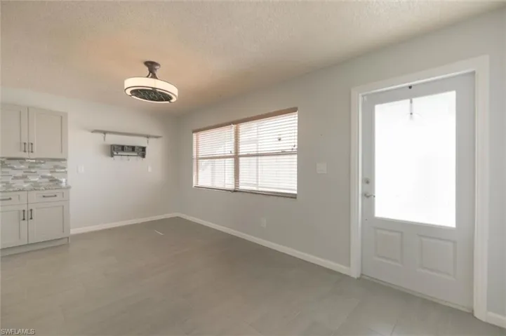 Unfurnished dining area with a textured ceiling
