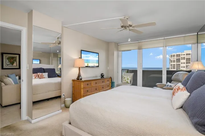 Bedroom with access to outside, light colored carpet, and ceiling fan