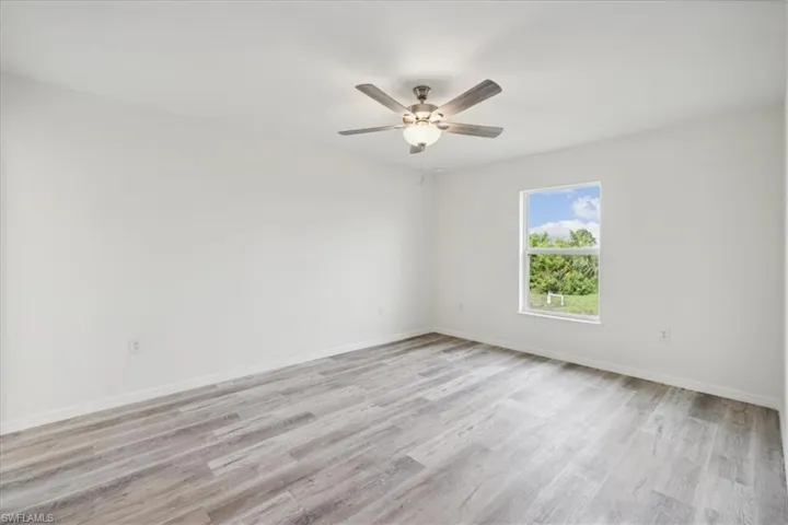 Spare room featuring light hardwood / wood-style floors and ceiling fan