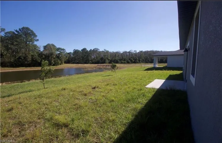 View of grassy yard with a water view
