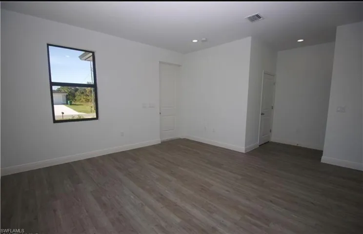 Unfurnished room featuring dark wood finished floors and recessed lighting