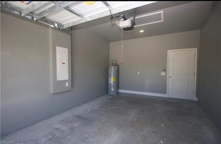 Garage with electric water heater and a garage door opener