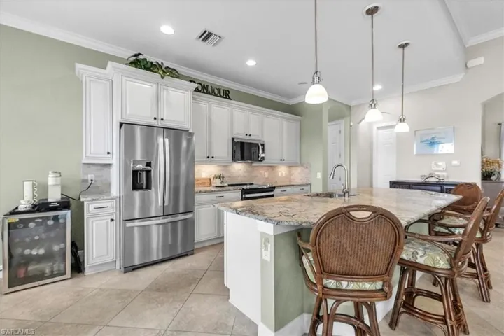 Kitchen with granite island and newer appliances