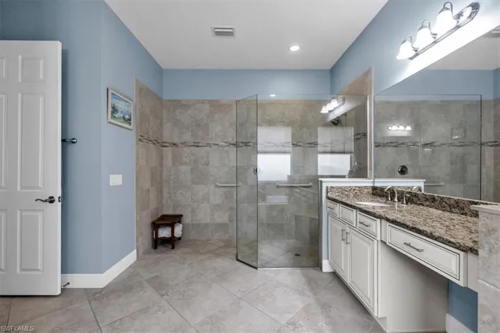 Master bath with separate dual sinks and large walk-in shower