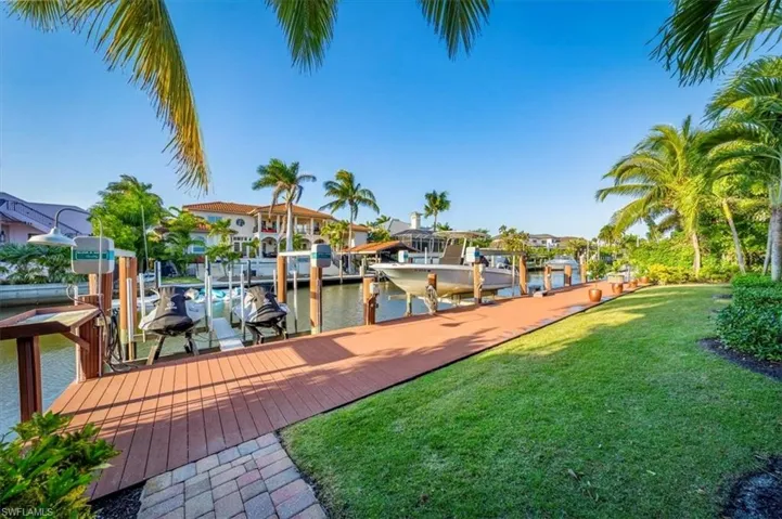 84 ft Azek dock which has a 13,000-pound capacity boat lift, double jet ski lift, filet table and fish light
