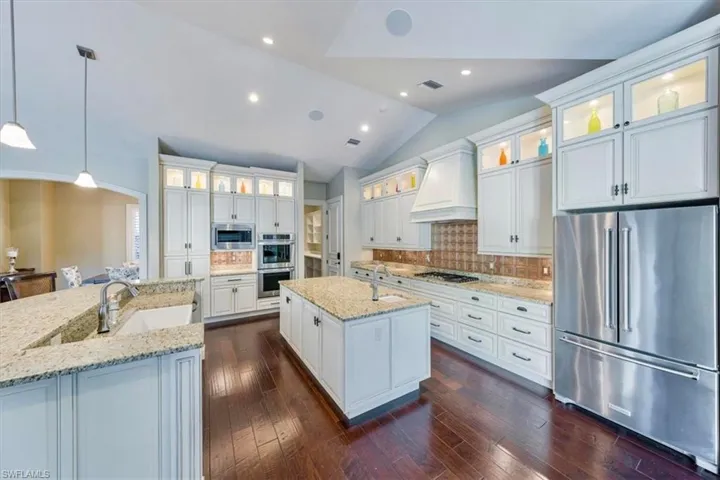 Gourmet kitchen features two islands, numerous custom cabinets, a butler’s pantry, 5-burner gas stove, two wine or beverage refrigerators and more