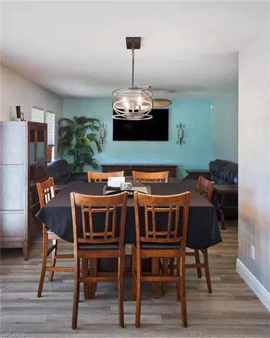 Dining room featuring wood-type flooring and an inviting chandelier
