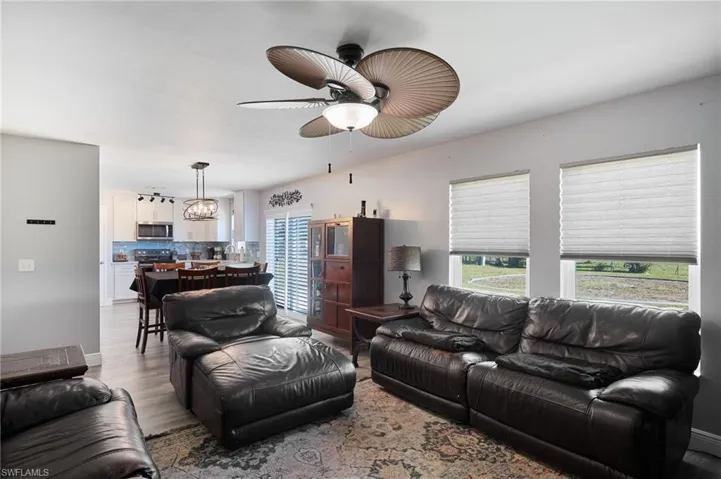 Living room featuring ceiling fan and light hardwood / wood-style floors